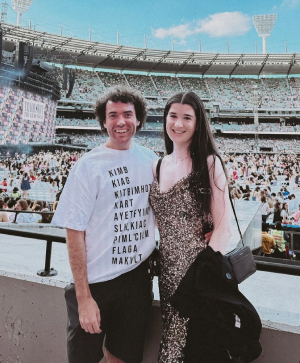 Bea and Sam at Era's Tour. Sam is wearing a t-shirt with the first letter of each lyric in Karma